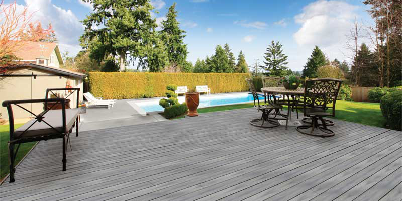 Photo courtesy MoistureShield Composite pool deck surround in residential backyard