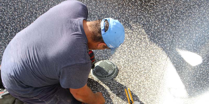 Pool professional installing a Virginia Graeme Baker Pool and Spa Safety Act (VGB Act) compliant pool drain cover. Photo by Jason Cramp