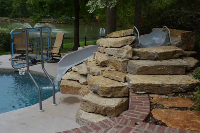 Photo courtesy Inter-Fab Inc. Pool slides built into the landscape best mimic those found at a waterpark.