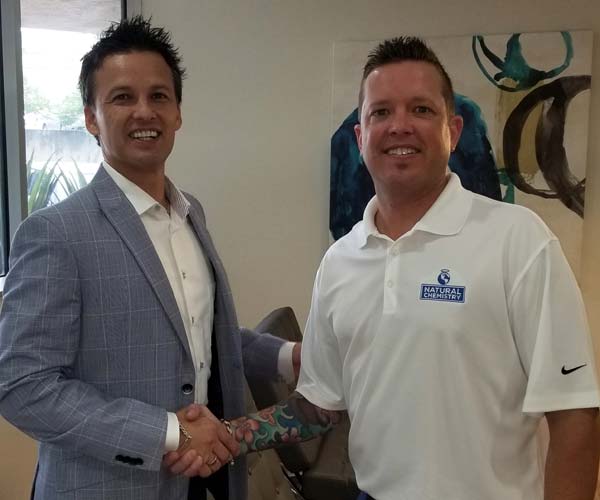Photo courtesy NC Brands Premier Pool Service, the sister company of Texas-based pool builder, Premier Pools & Spas, has signed a partnership agreement with NC Brands. Pictured left to right are Charles Lauller, Premier Pool Service president and NC Brands regional manager, Ryan Rickaby.