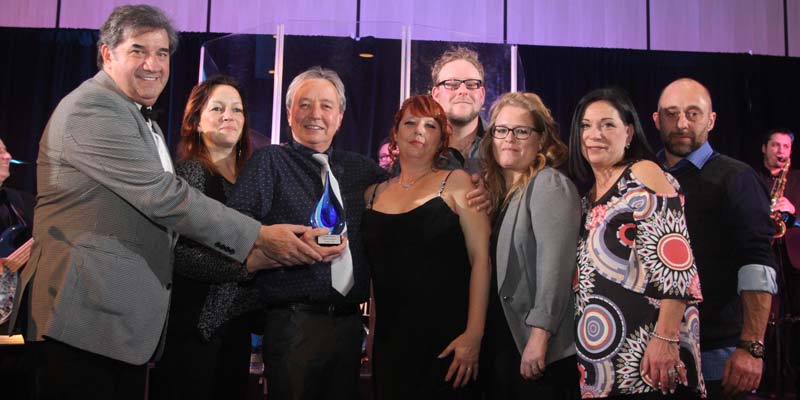 Photo courtesy Association des commerçants de piscines du Québec (ACPQ) Gérard Charlebois congratulates Spas 4 Saisons who have won several awards. Congratulations to Caroline Berthiaume and Dany Perreault, both owners, and their talented team.