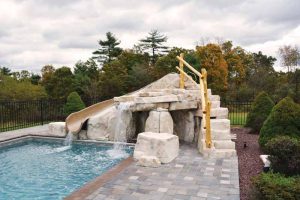 Photo courtesy Bob's Pools These nature-inspired elements can be built to incorporate fun accessories like slides, waterfalls, and jump rocks which are then blended with pavers and other hardscape decks.