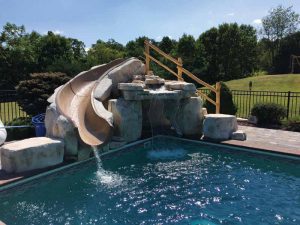 Photo courtesy Bob's Pools Many manufacturers offer component systems that allows installers to build rock staircases to incorporate slides into the structures.