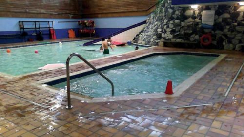 Photo courtesy Stainless Steel Pool & Spa earl mah aquatic centre. The 18-m2 (194-sf) wide skimmer whirlpool, with a volume of 10,834 L (2862 gal), was located in the middle of the building. It was built of concrete and finished with tiles. The current pool technology room is located behind the back wall of the pool.