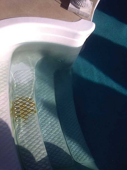 To identify the stain type, one must determine the metal present in the pool water and further test it to see if it can be lifted from the surface of the vessel.