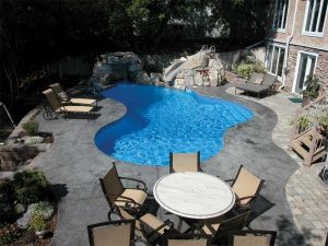 Photo courtesy RicoRock Inc. Slides provide a perfect opportunity to fill in behind, under, and around the slide with artificial rock water features.