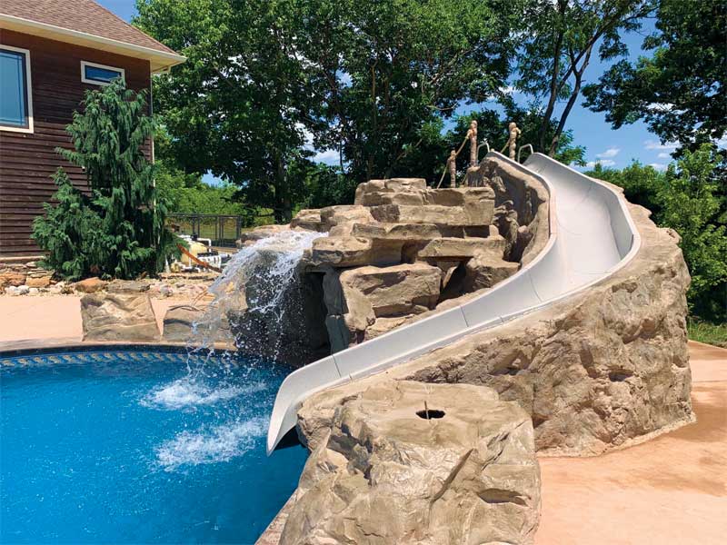 Photo courtesy Lambert Custom Pools GFRC panels can be a clever way to integrate accessories such as slides into the deck and coping.