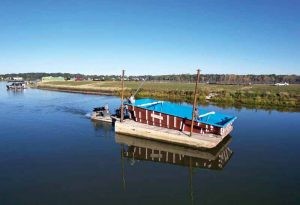 A barge was used to deliver five fibreglass pools to backyards located along a large reservoir in McCordsville, Indiana.