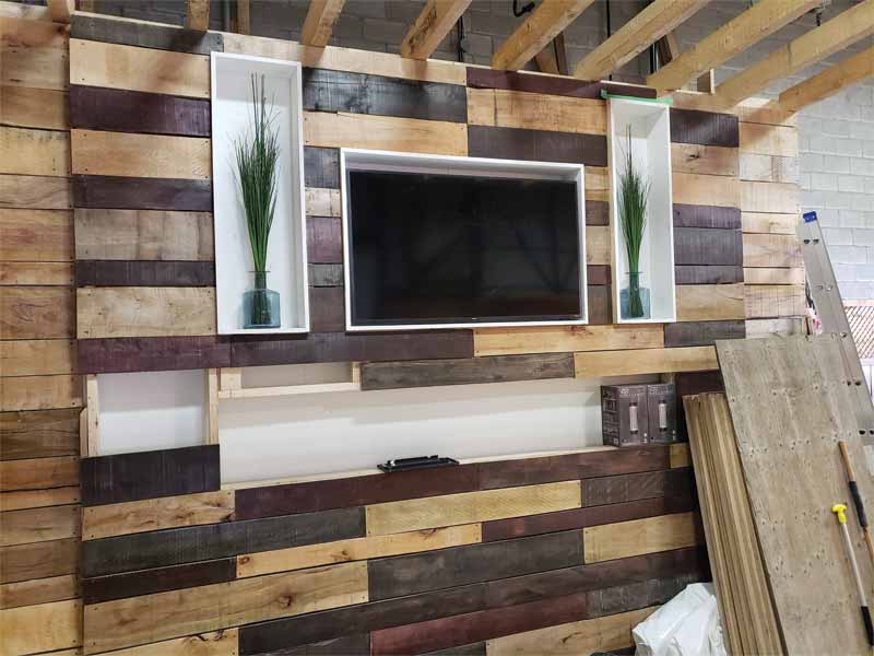 In the winter of 2020, a hardwood accent wall with a television and fireplace was constructed.