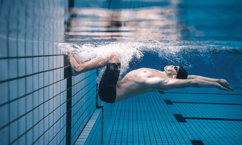 male swimming in water
