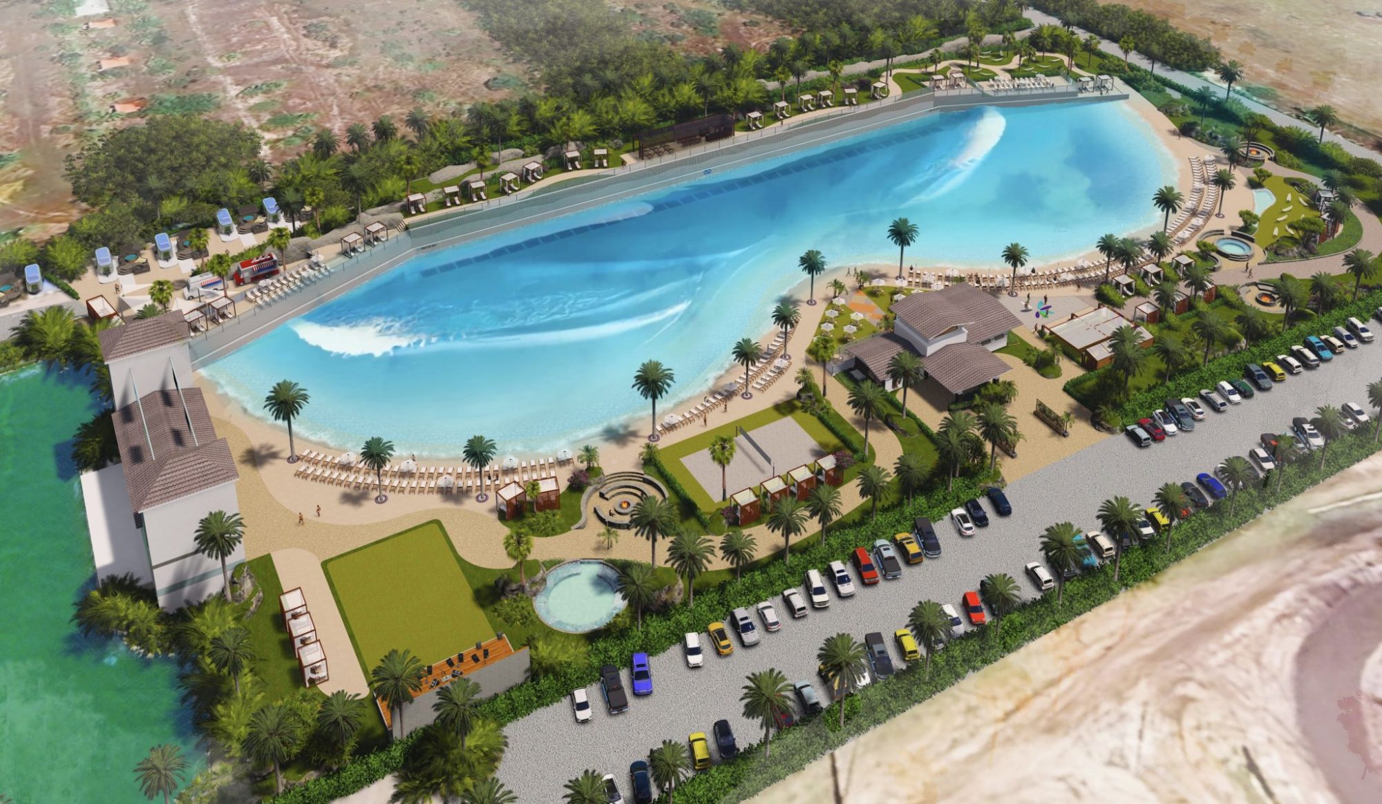 Aerial view of a vibrant resort featuring a wave pool, sun loungers, palm trees, and a parking area lined with cars.