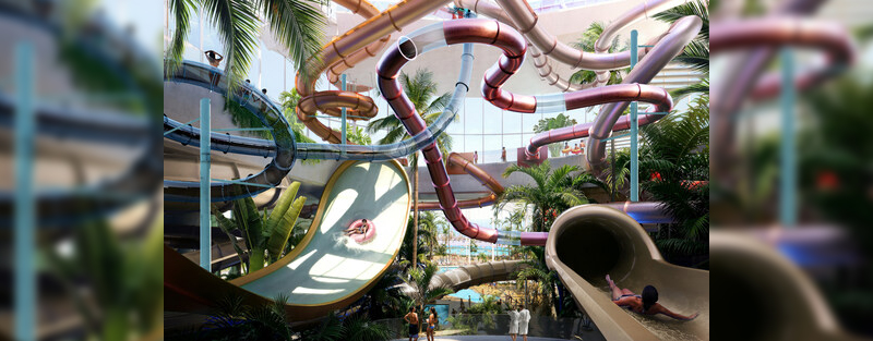 A vibrant indoor water park featuring colorful water slides, lush palm trees, and visitors enjoying the attractions.