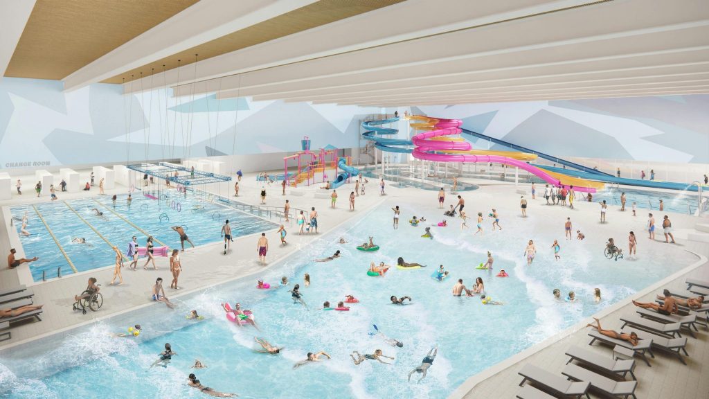 A bustling indoor waterpark featuring multiple pools, water slides, children playing, and loungers, with various activities and guests enjoying.