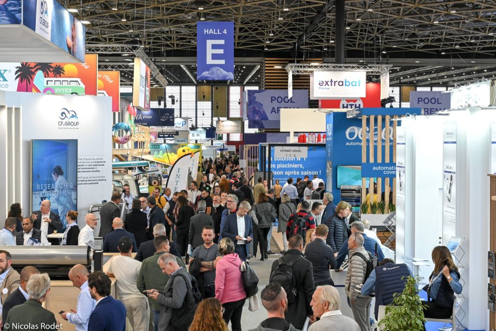 A crowded exhibition hall labeled 